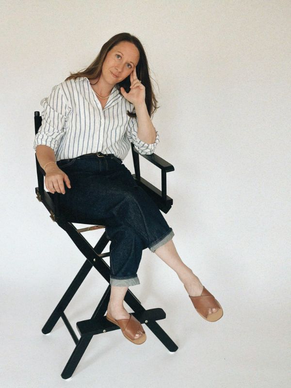 Alexis Jacobson, web designer for small Maine businesses, sits in a directors chair.