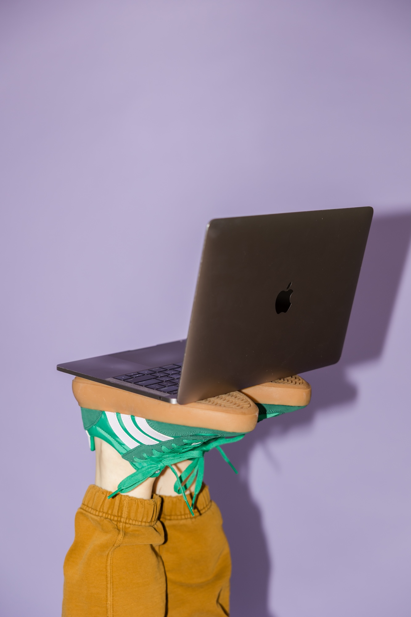 Alexis Jacobson, a Maine website designers, balances her computer on her feet.